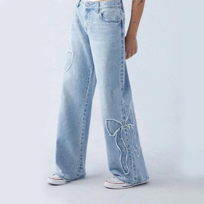 Wiga - pantalon denim avec broderie en forme de boucle