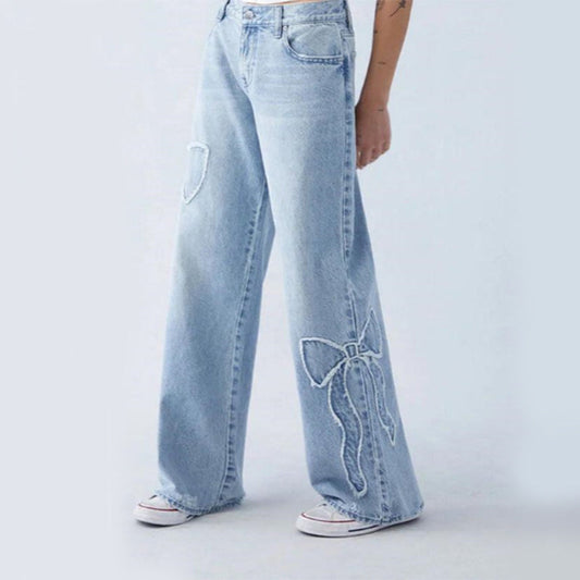 Wiga - pantalon denim avec broderie en forme de boucle