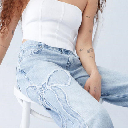 Wiga - pantalon denim avec broderie en forme de boucle